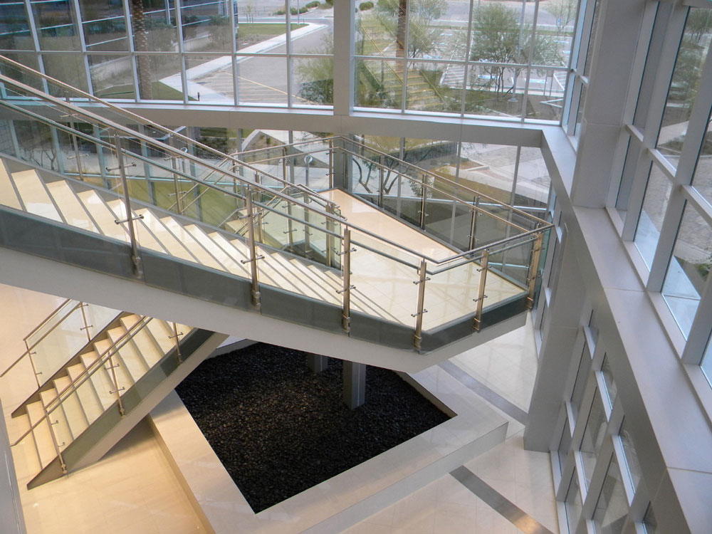 Continium - glass with stainless steel post, cap rail and handrail.