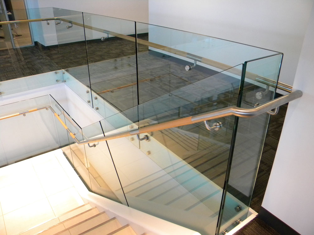 QBE - glass with stainless steel puck system. Stainless steel and wood handrail.