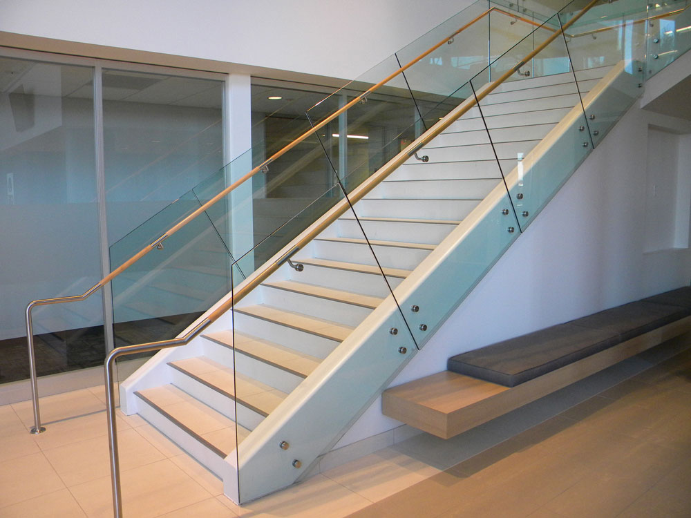 QBE - Glass with stainless steel puck system. Stainless steel and wood handrail.