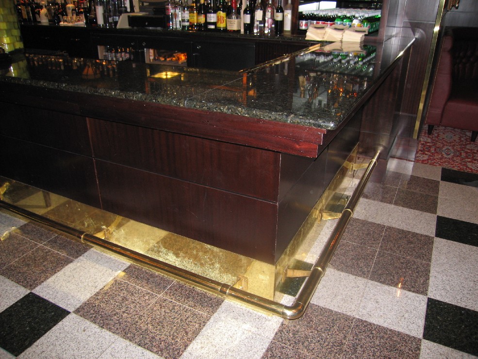 Capitol Grill. Brass wall support with kick plate.