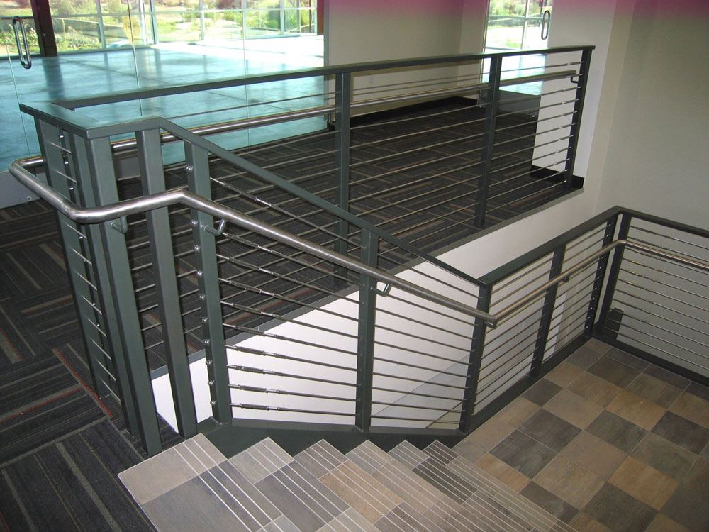 Irgens - Stainless steel cable and handrail on painted steel post.
