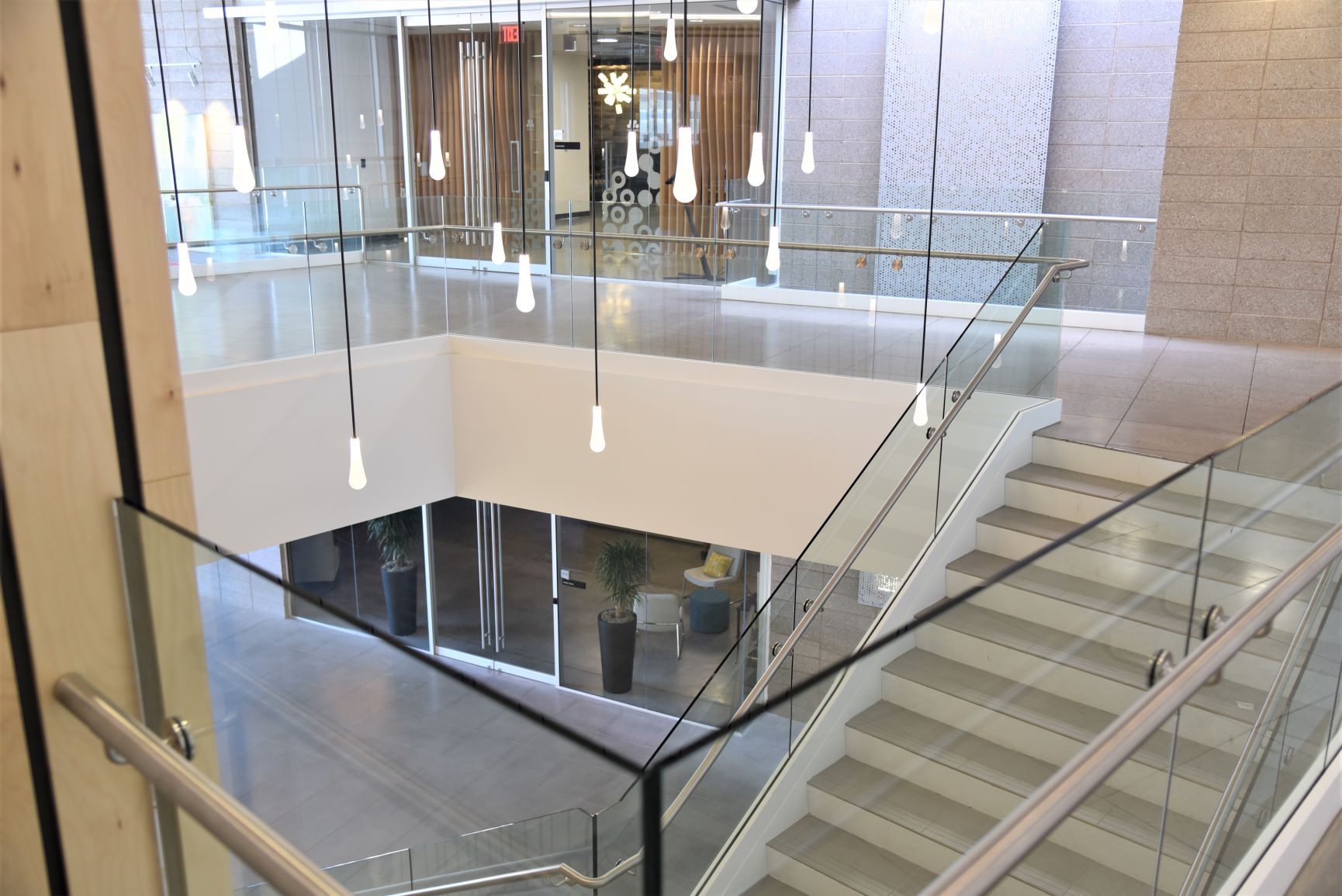 Scope: Stainless steel glass railings with painted steel base cladding.
